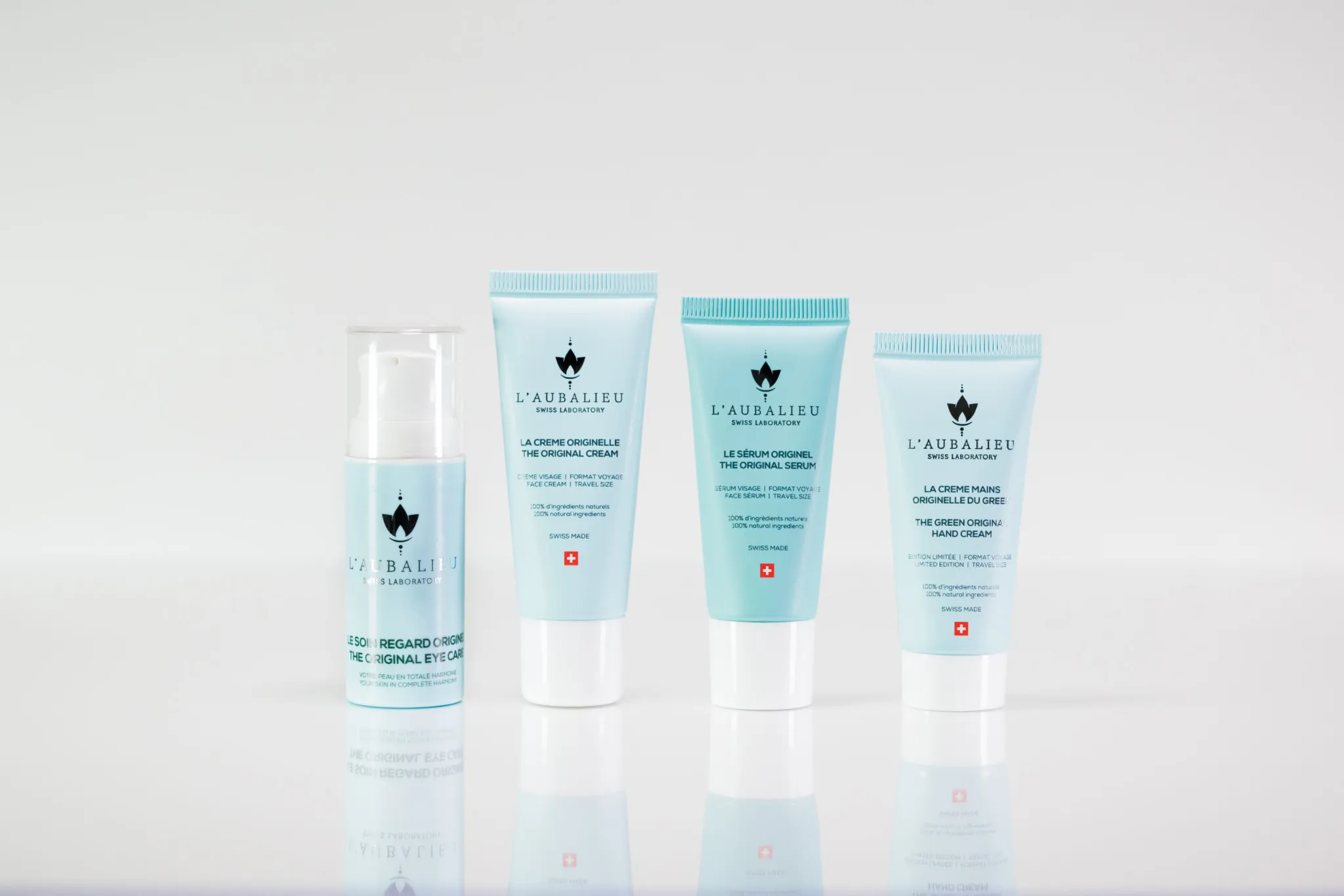 Collection complète de produits de soin L'Aubalieu en taille de voyage, présentée sur un fond blanc.